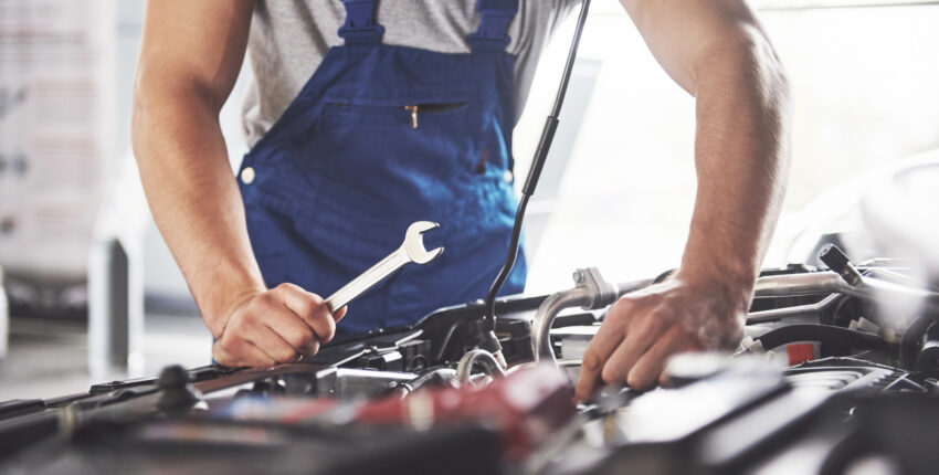 Mechanic conducting repairs on engine bay