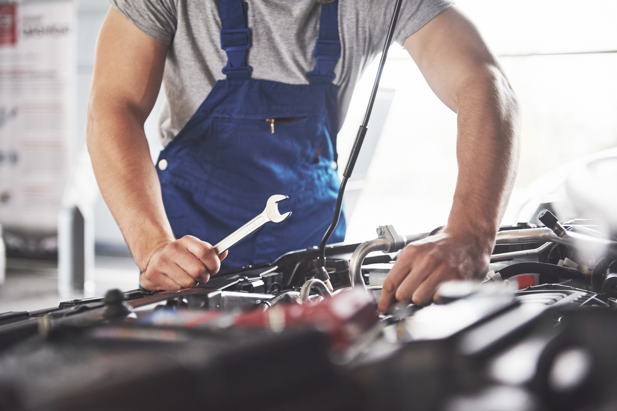 Mechanic conducting repairs on engine bay